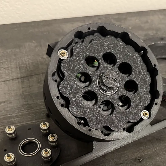 A 3D-printed cycloidal gearbox opened up, showing the lobed cycloid disc and its roller pins